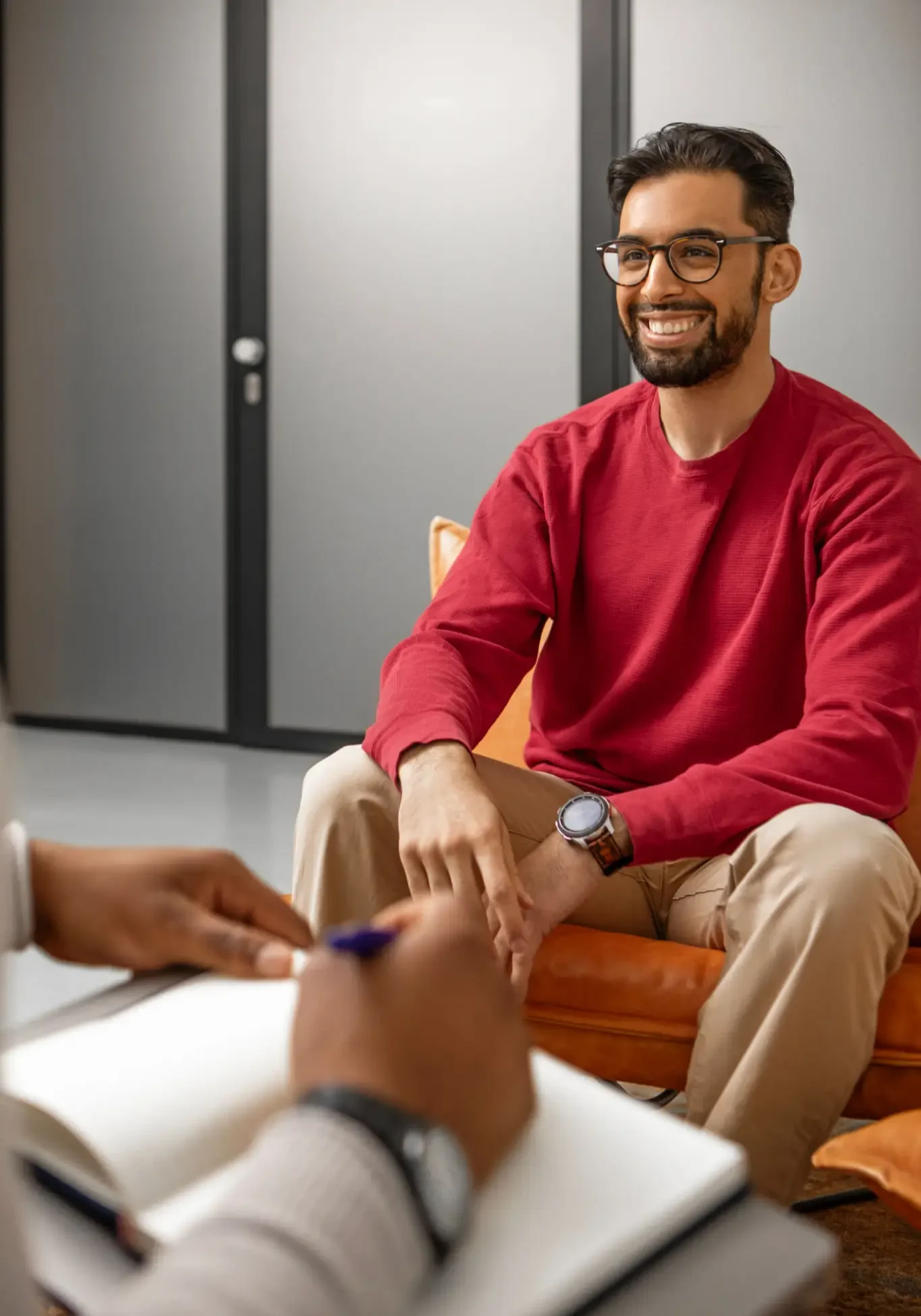 Smiling man in red sweater during therapy